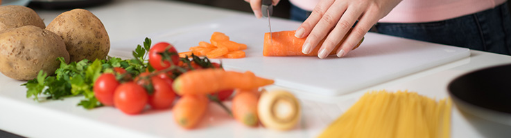 person cutting up vegetables