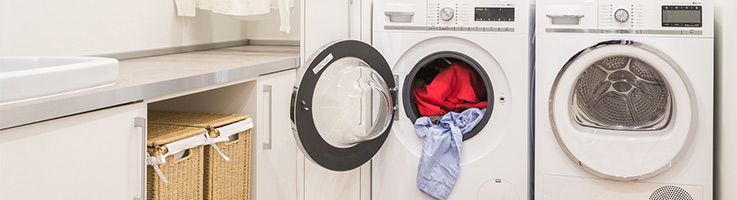 washer and dryer with clothes in the dryer