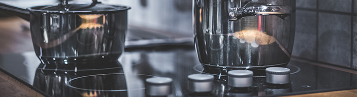 two pots sitting on an electric range