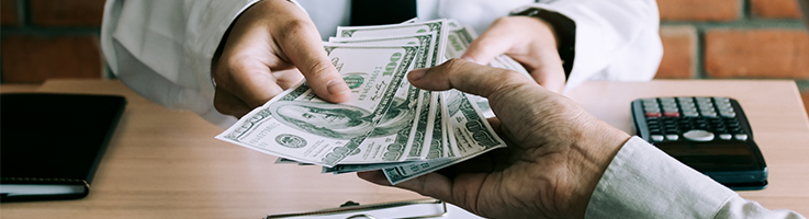 man handing money to another man