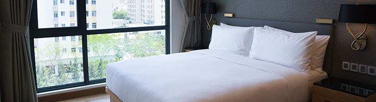 white bed next to panoramic window